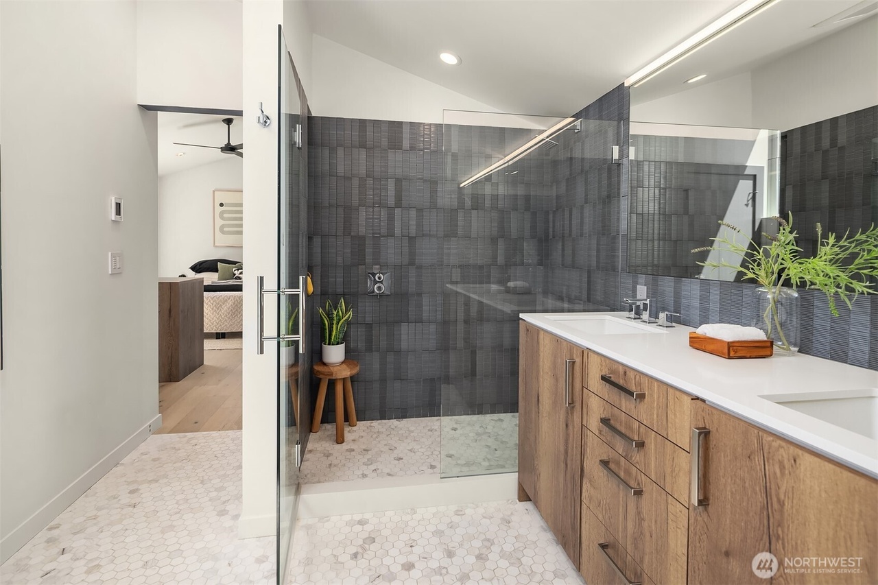 Contemporary bathroom with wood vanity and walk-in dark grey tile shower