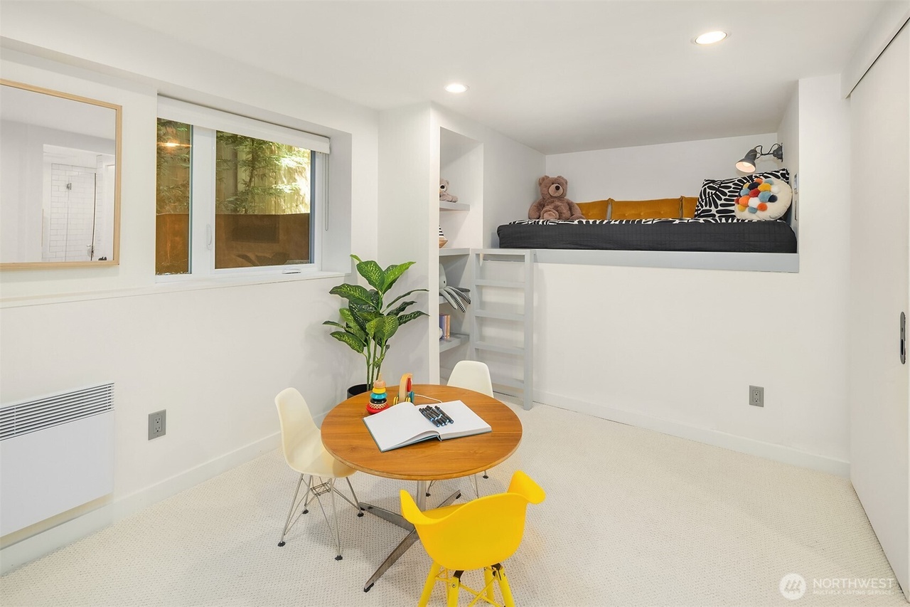 Children's playroom and bedroom with loft bed and activity table