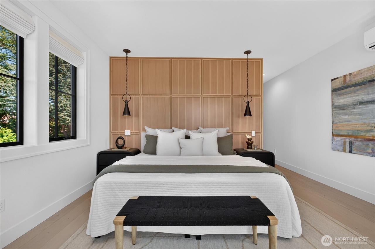 Contemporary bedroom with grid-paneled wood accent wall and pendant lighting