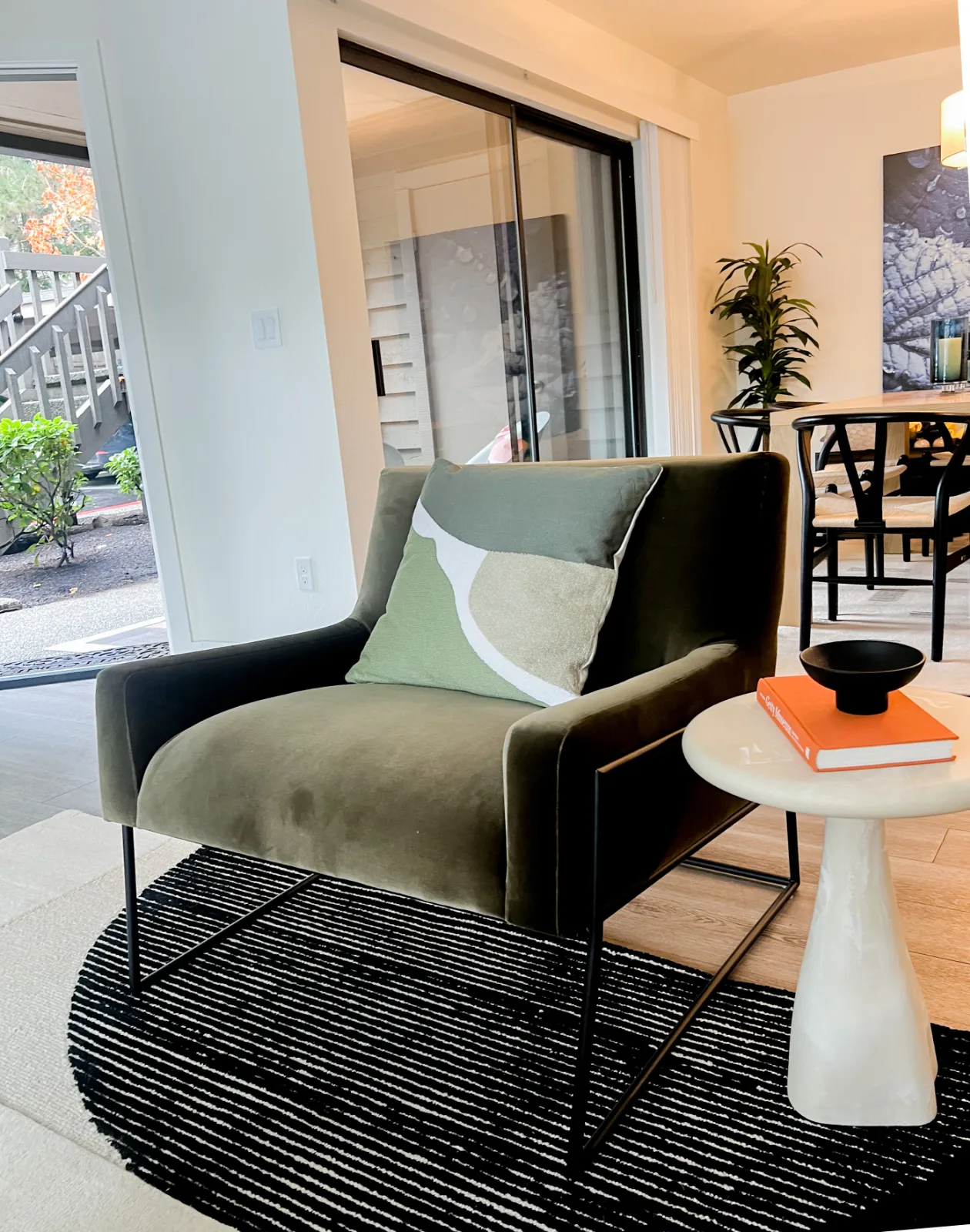 The Park in Bellevue: Olive green velvet armchair and striped rug vignette
