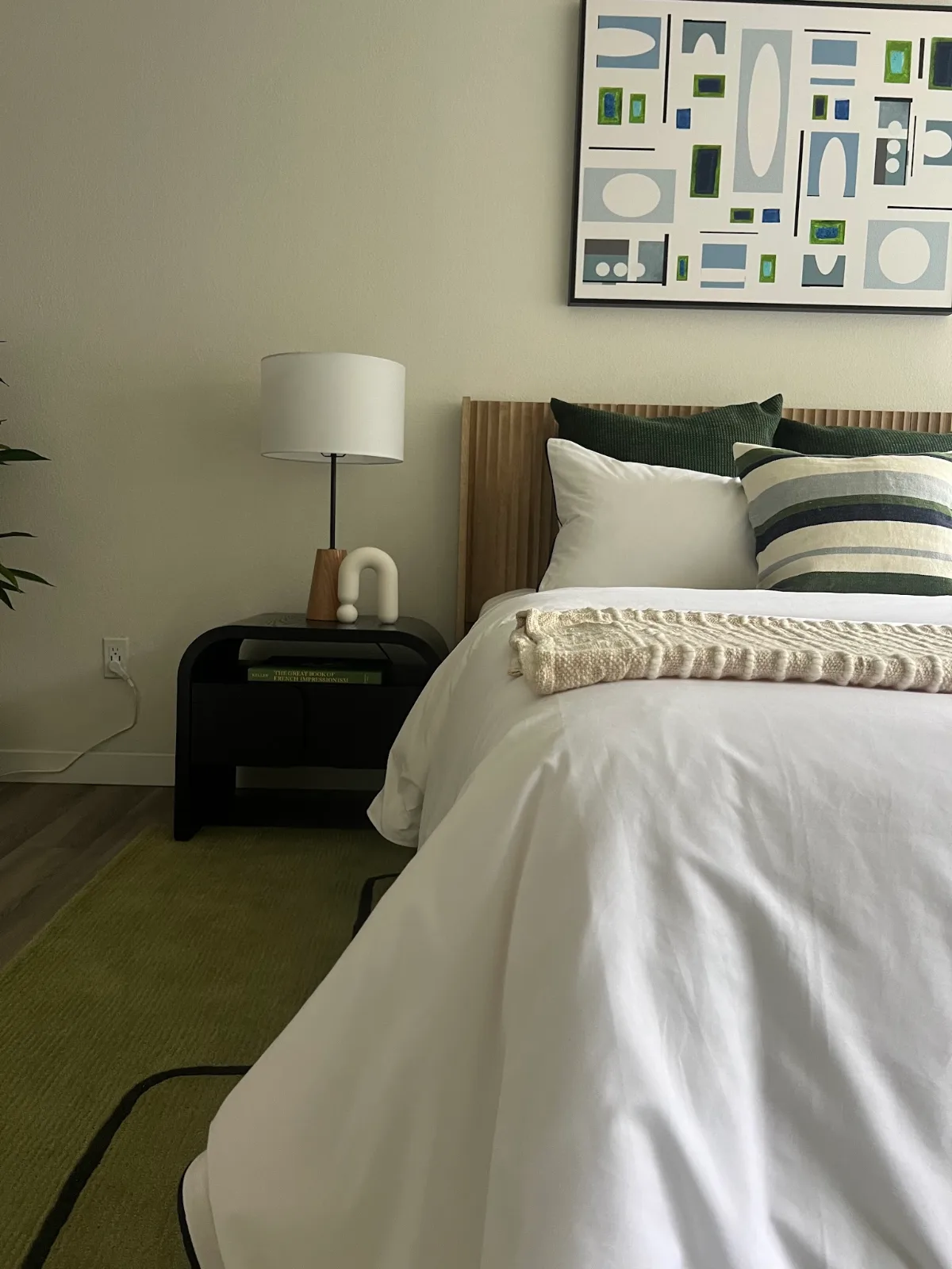 The Park in Bellevue: Bedroom corner with black nightstand and framed art