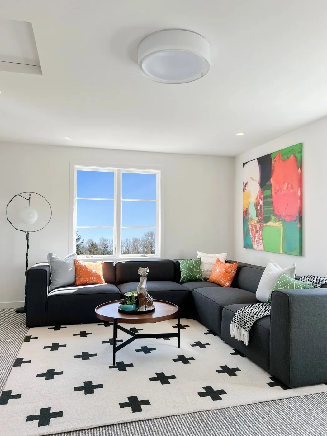 Charcoal sectional living room styled with colorful accents