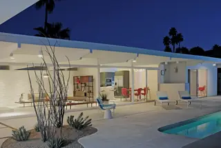 Illuminated mid-century modern house at dusk