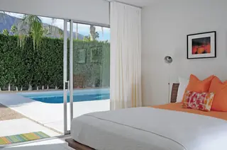 Bright mid-century modern bedroom with orange accents