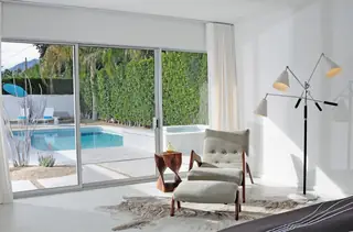 Modern room with cowhide rug and mid-century armchair