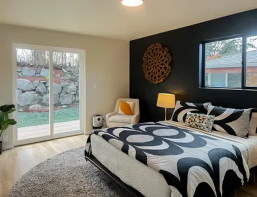 Modern bedroom with graphic black-and-white bedding and outdoor patio access